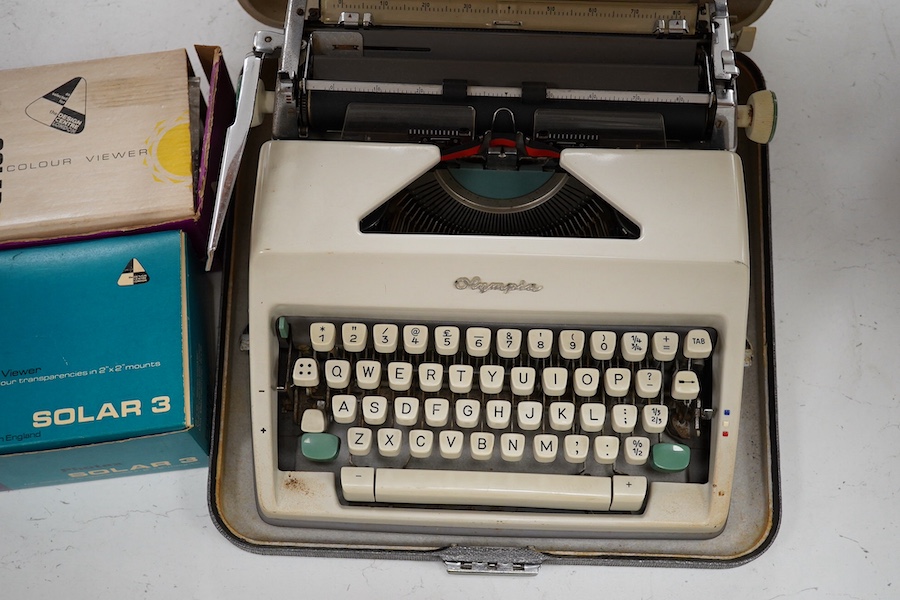 An Olympia typewriter and two 1960s slide viewers, typewriter 37cm x 35cm. Condition - untested if in working order.